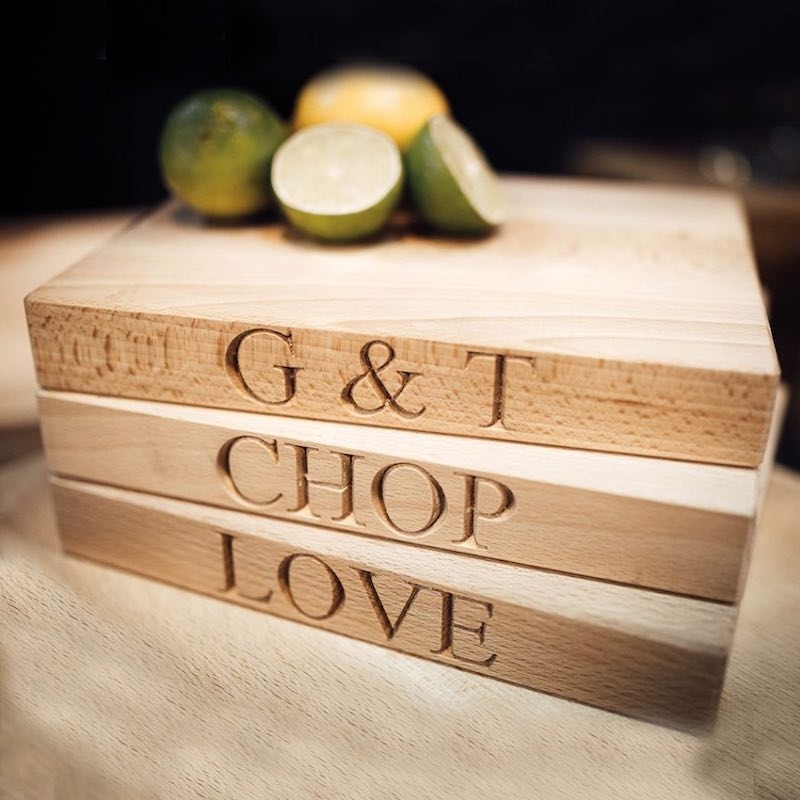 Some wooden labeled chopping boards - ' G & T' , 'CHOP' and 'LOVE'