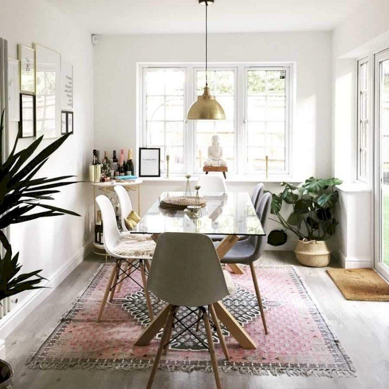 A brass Brooklyn dome light over a modern dining room table. 