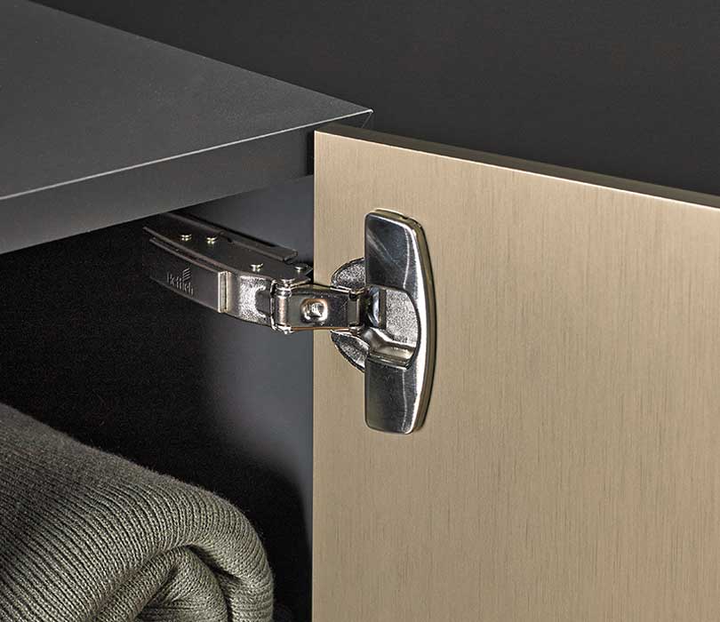 Image Credit: Hettich
Product: Sensys Soft Close Concealed Hinge
Image shows open cupboard with Hettich soft close cabinet hinge extended